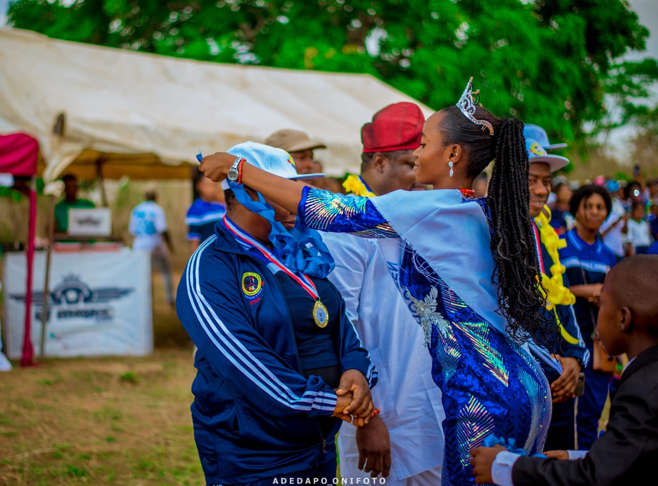 Student honoring sports official with medal