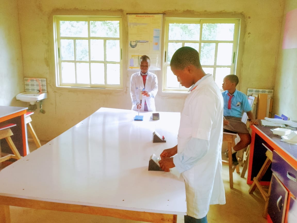 Students presenting experiment in science lab