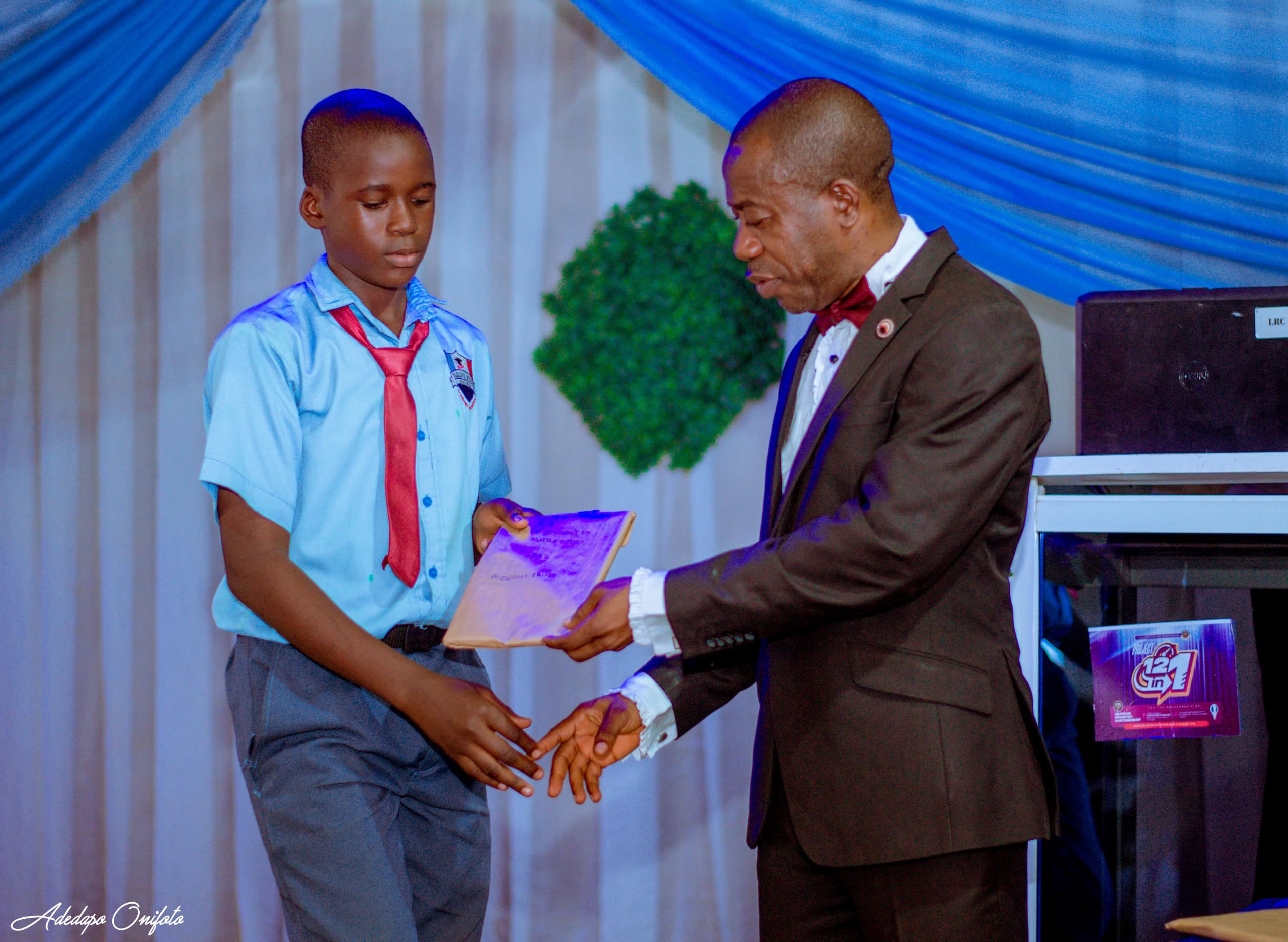 Student receiving merit award on stage