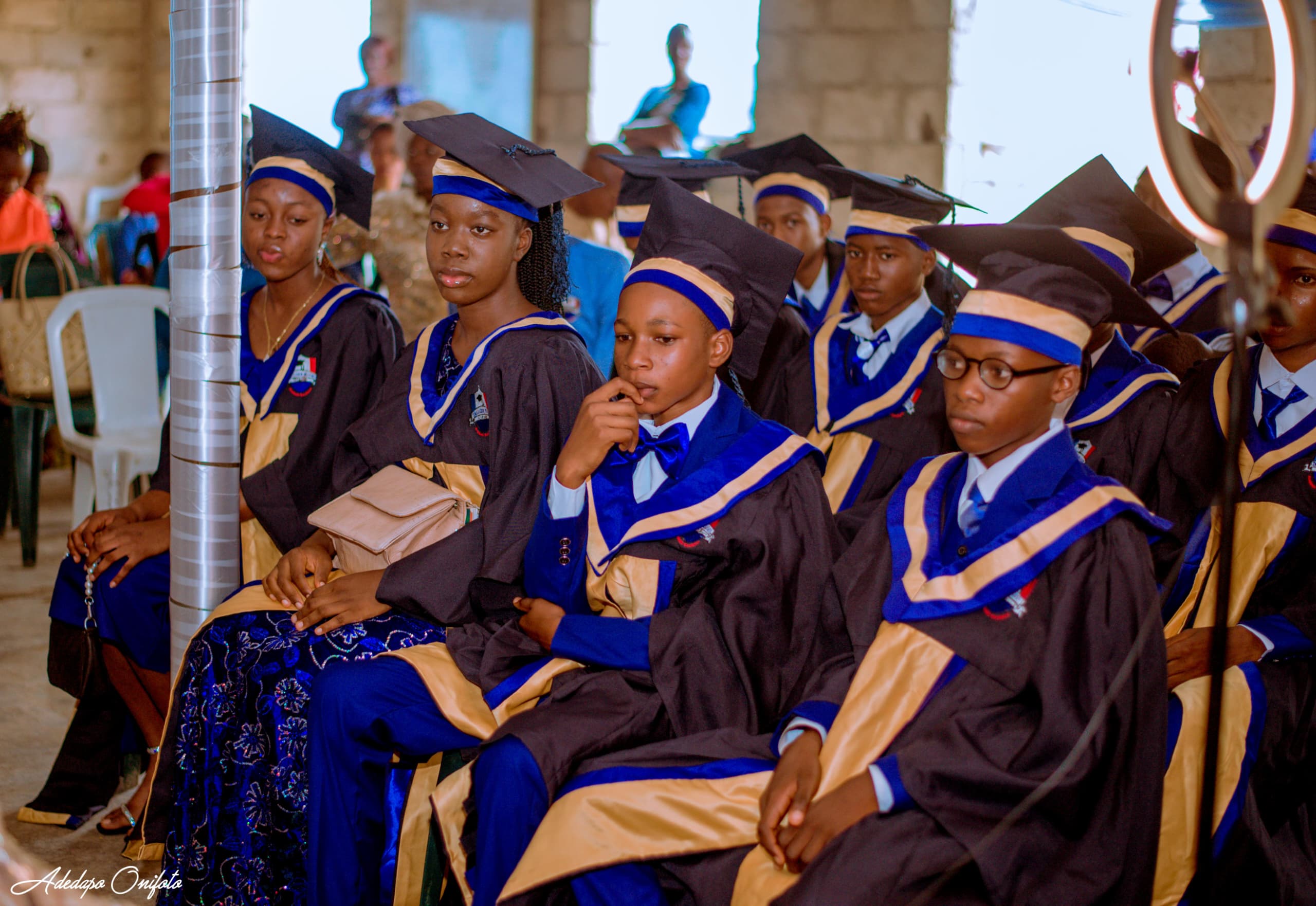 Graduating pupils seated in ceremony gowns