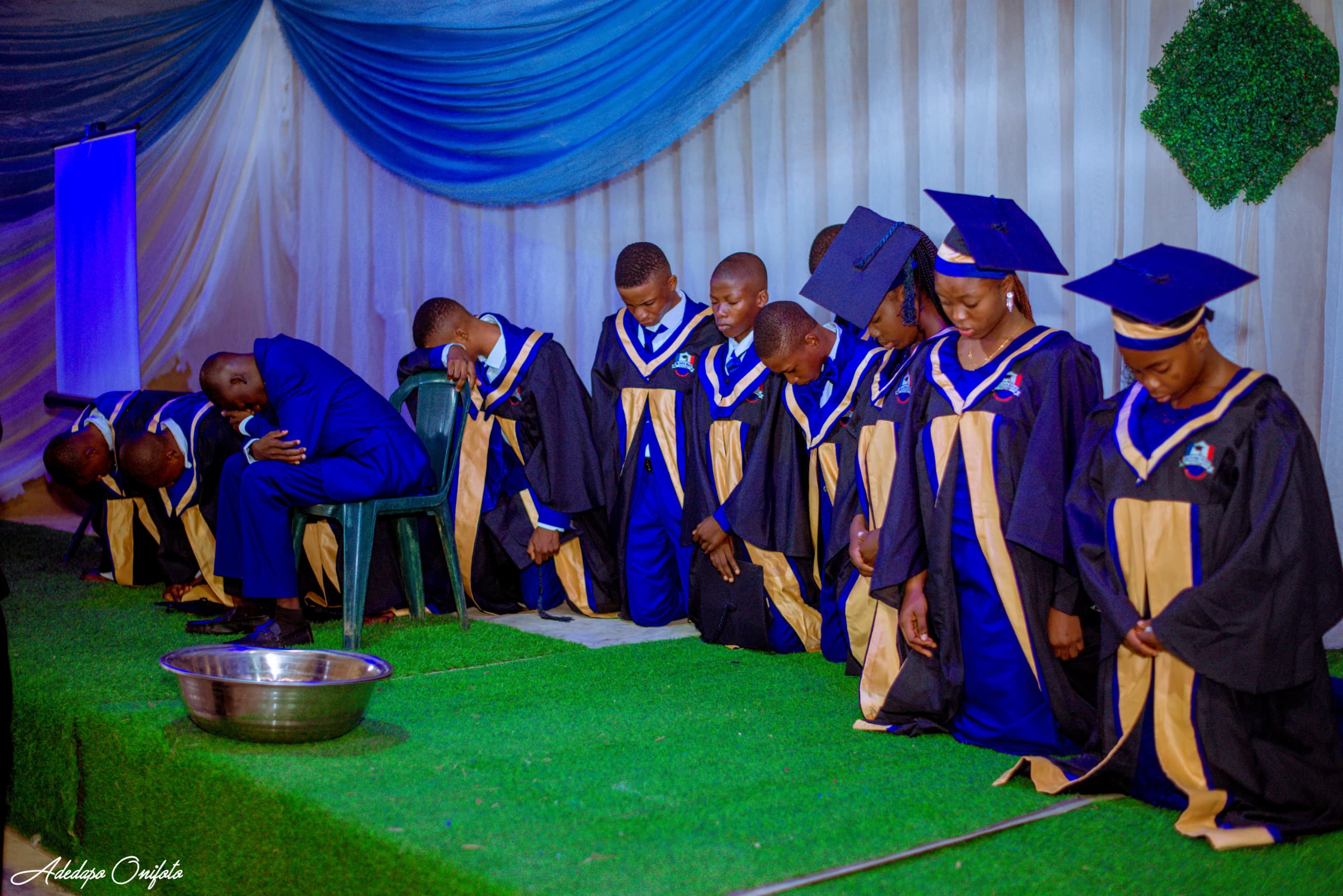 Graduates in prayer during graduation service