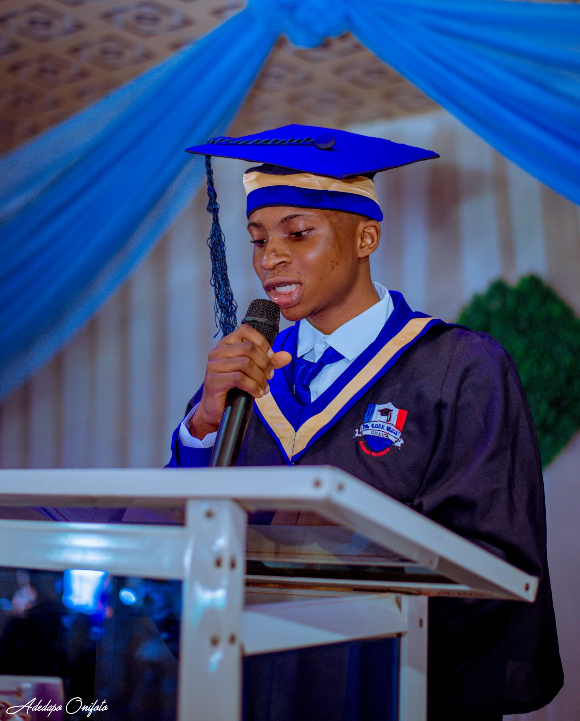 Graduate giving valedictory speech at podium