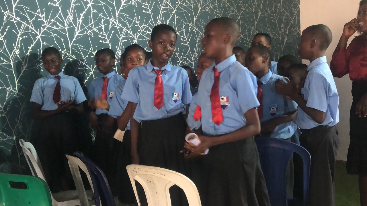 Students singing at indoor school program